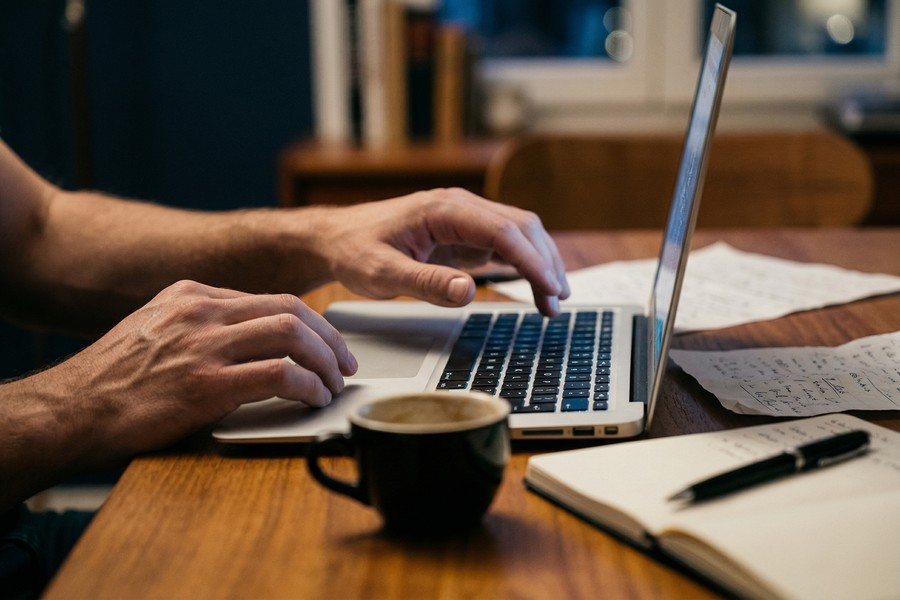 Confident professional reviewing salary data on laptop before a job offer negotiation call
