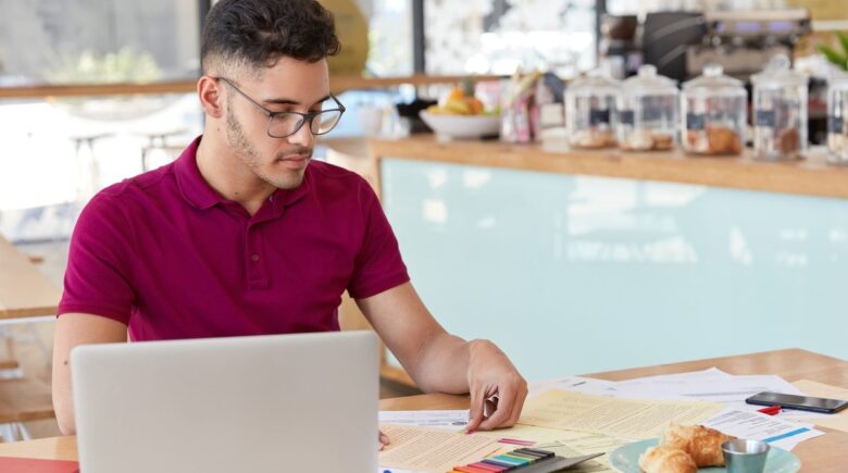 Person reviewing monthly budget spreadsheet with variable income columns