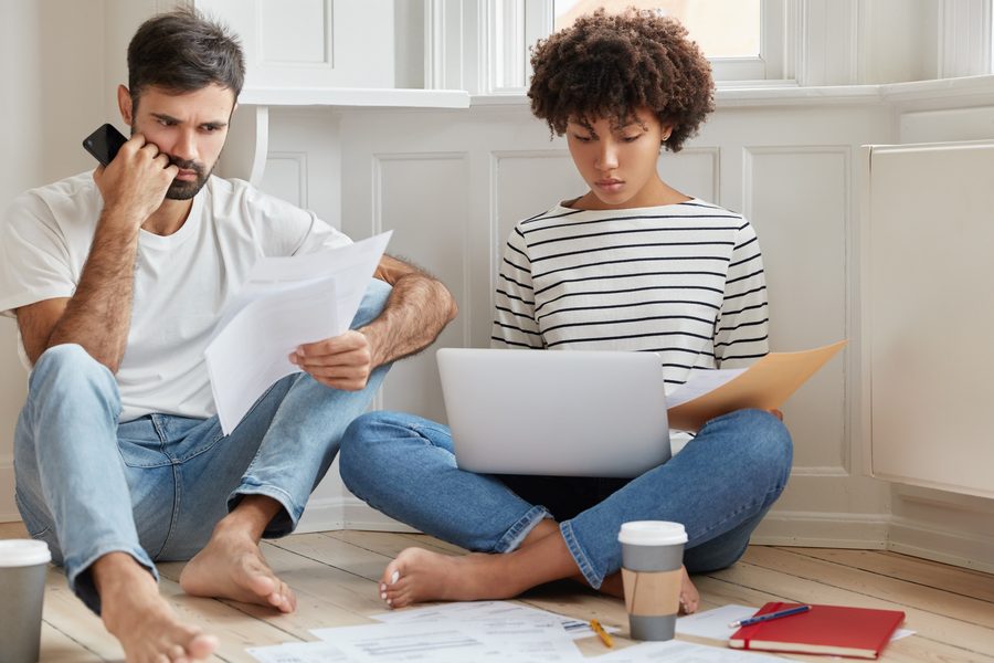 Landlord reviewing mortgage documents and tenant rent ledger