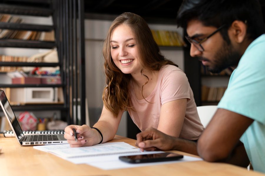 A 25-year-old comparing student loan payments to investment growth on a laptop