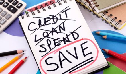 Person reviewing credit card statements and payment strategy during rising interest rates