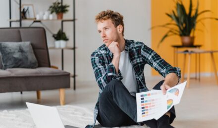 Real estate investor analyzing portfolio stress test scenarios with mortgage rate and insurance cost charts
