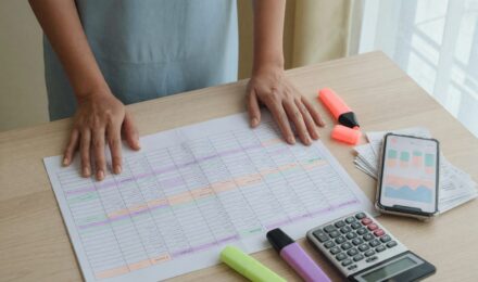 Gig worker reviewing zero-based budget spreadsheet on laptop with income and expense categories